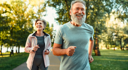 Elderly couple jogging and smiling