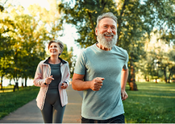 Elderly couple jogging and smiling