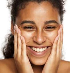 Photo of smiling woman holding her hands to her cheeks