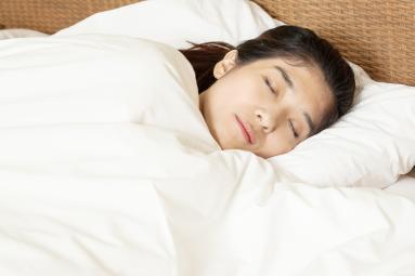 young woman sleeping in bed